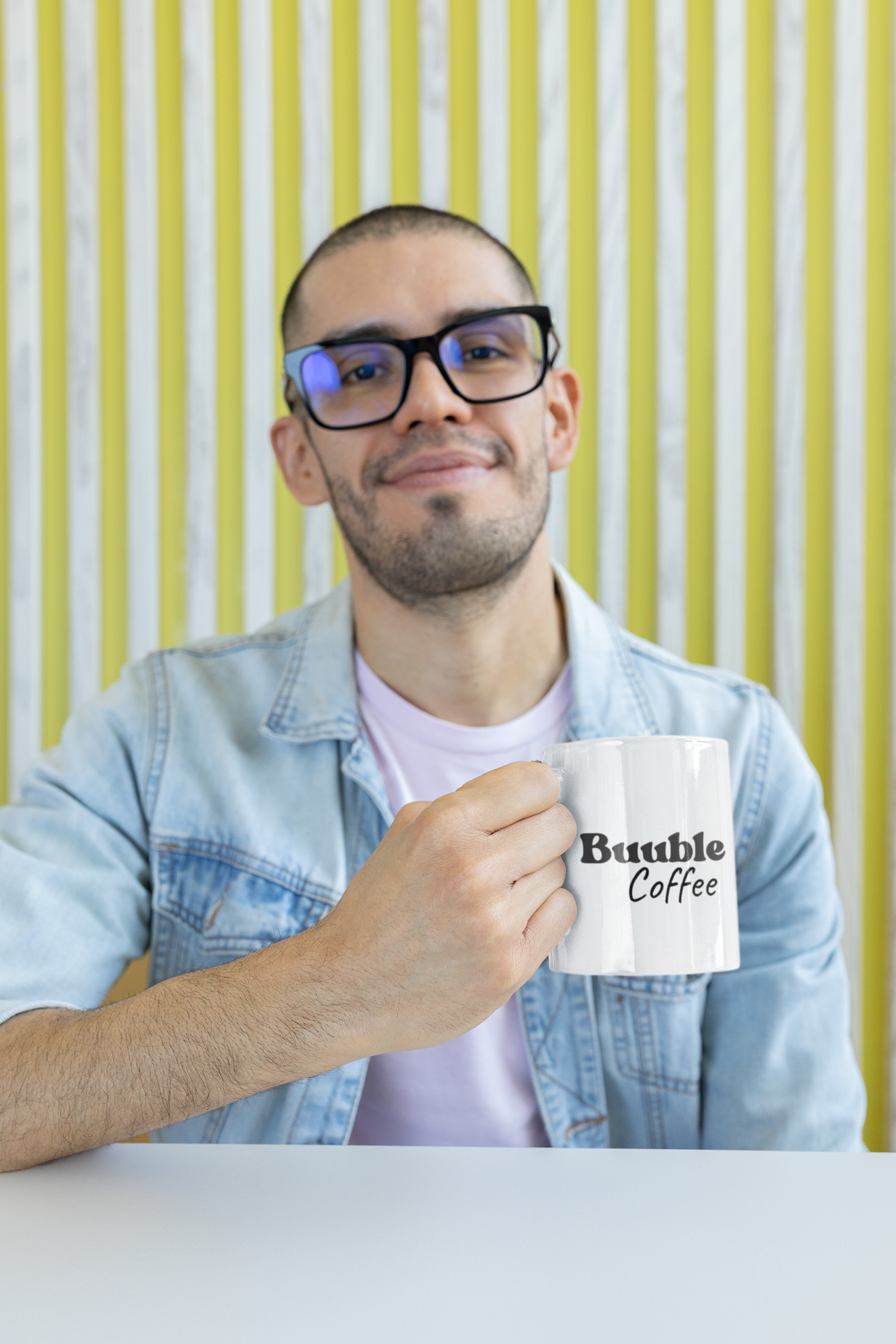 Man holding a coffee mug with a striped background