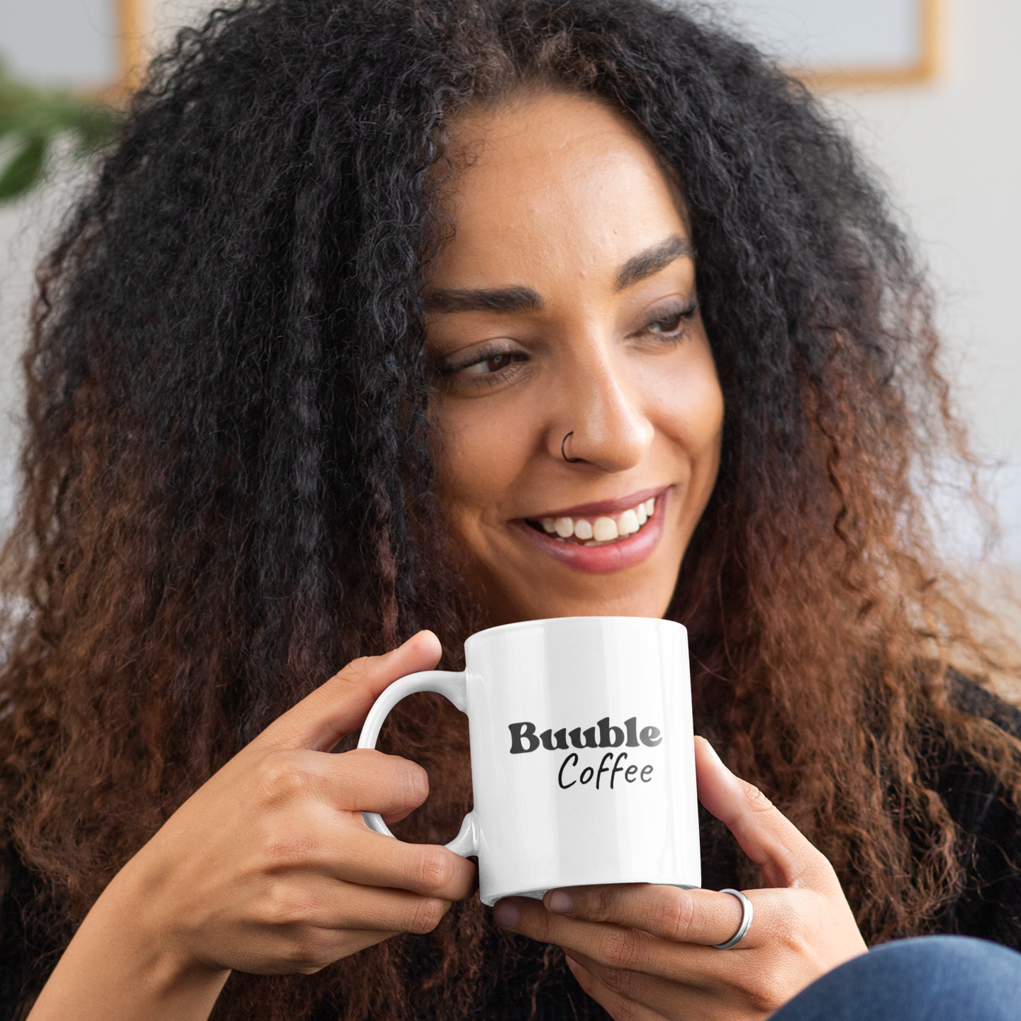 Woman holding a white mug with 'Buuble Coffee' text.