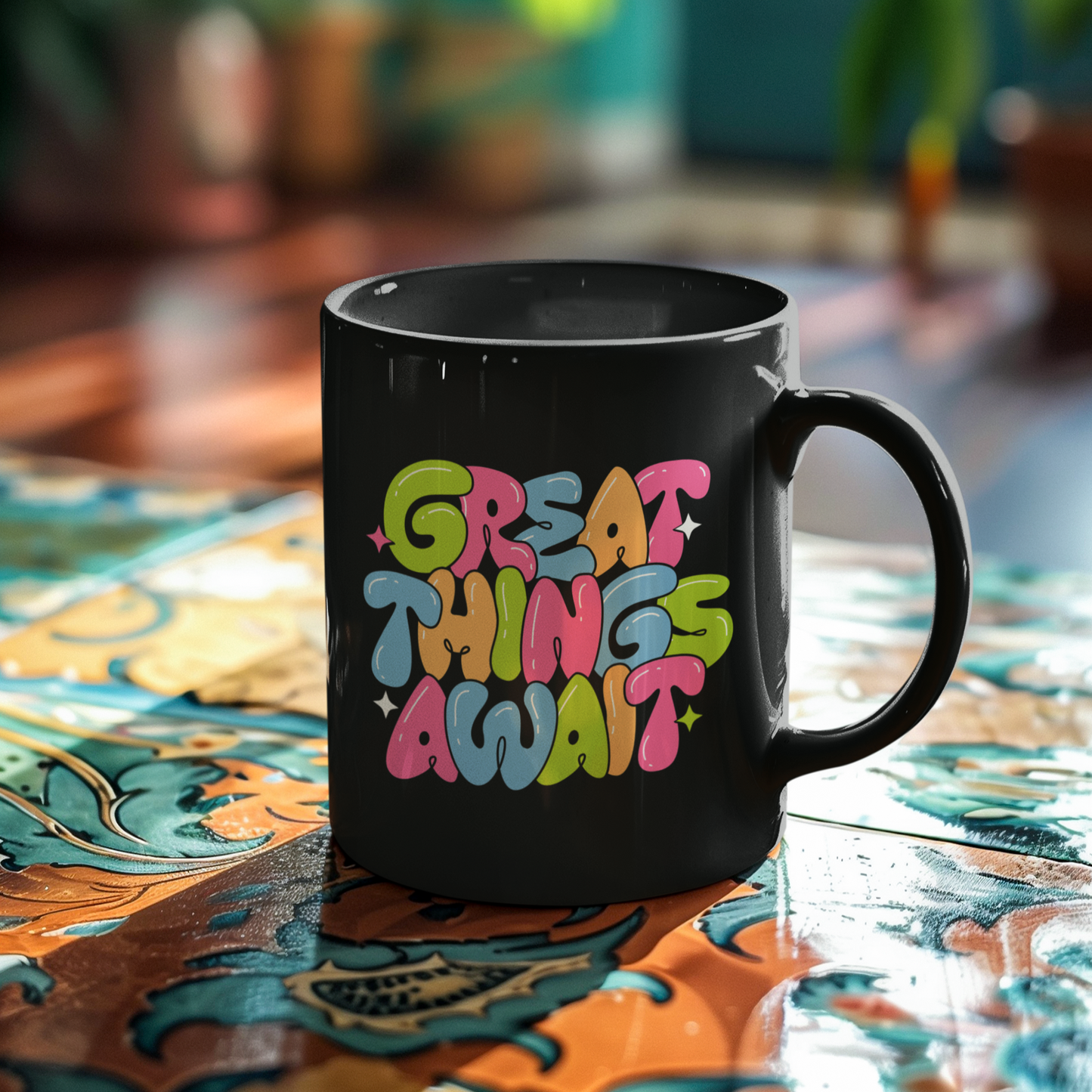 Black mug with 'Great Things Await' text on a colorful table.