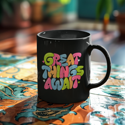Black mug with 'Great Things Await' text on a colorful table.