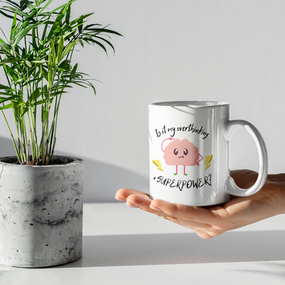 Hand holding a mug with a pig design and text next to a potted plant.