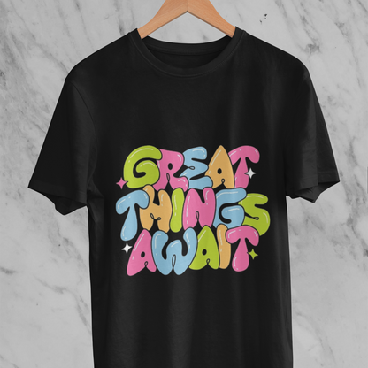 Black t-shirt with 'Great Things Await' text in colorful letters on a marble background