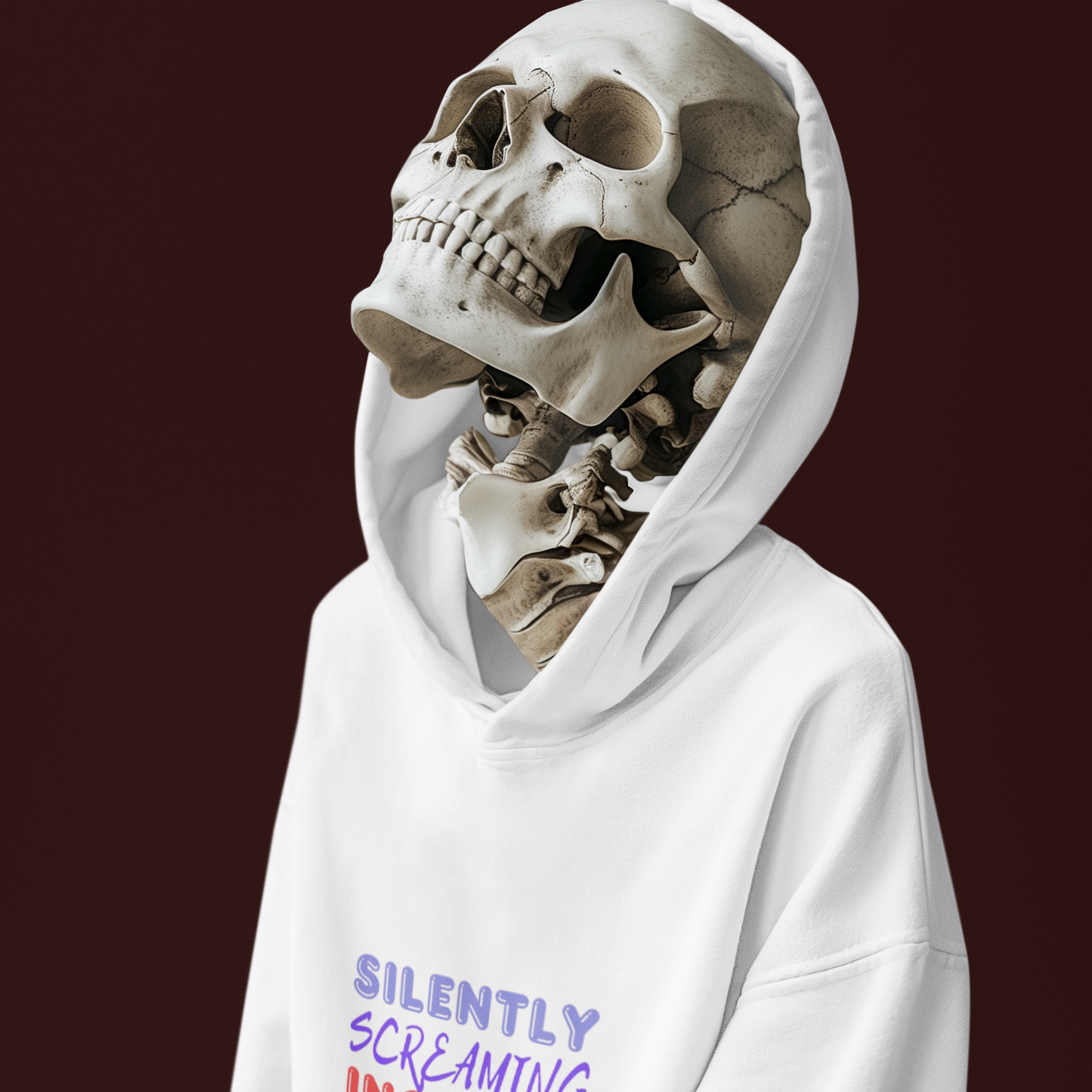 Person wearing a white hoodie with a skeleton head design on a dark background