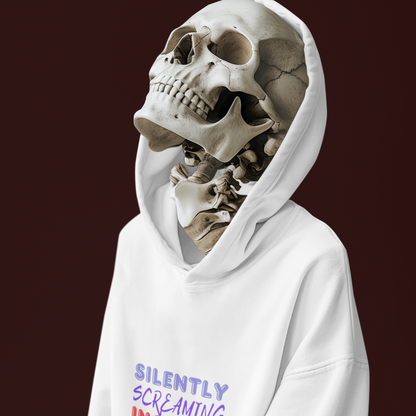 Person wearing a white hoodie with a skeleton head design on a dark background