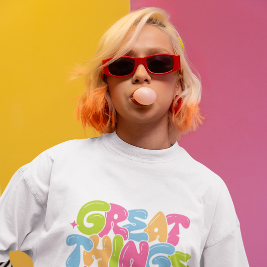 Person wearing a white sweatshirt with colorful text against a multicolored background